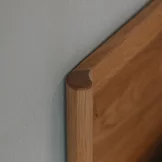 detailed view of the design of the solid wood headboard of the times bed in solid oak