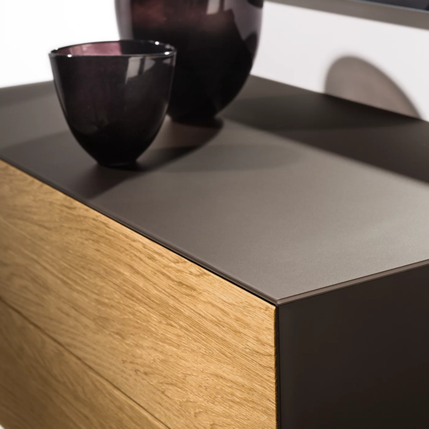 cubus pure chest of drawers in oak with coloured glass surround in graphite grey