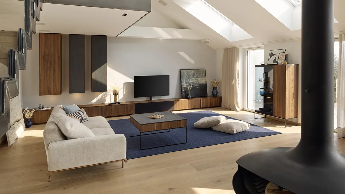 filigno wall unit, display cabinet and coffee table in walnut and basalt black ceramic in a modern living room