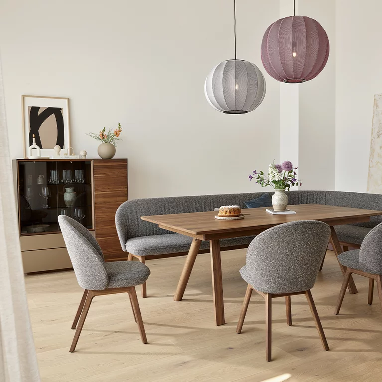 flor dining chairs in fabric seat shell and fabric backrest with wooden frame in walnut and taso solid dining table