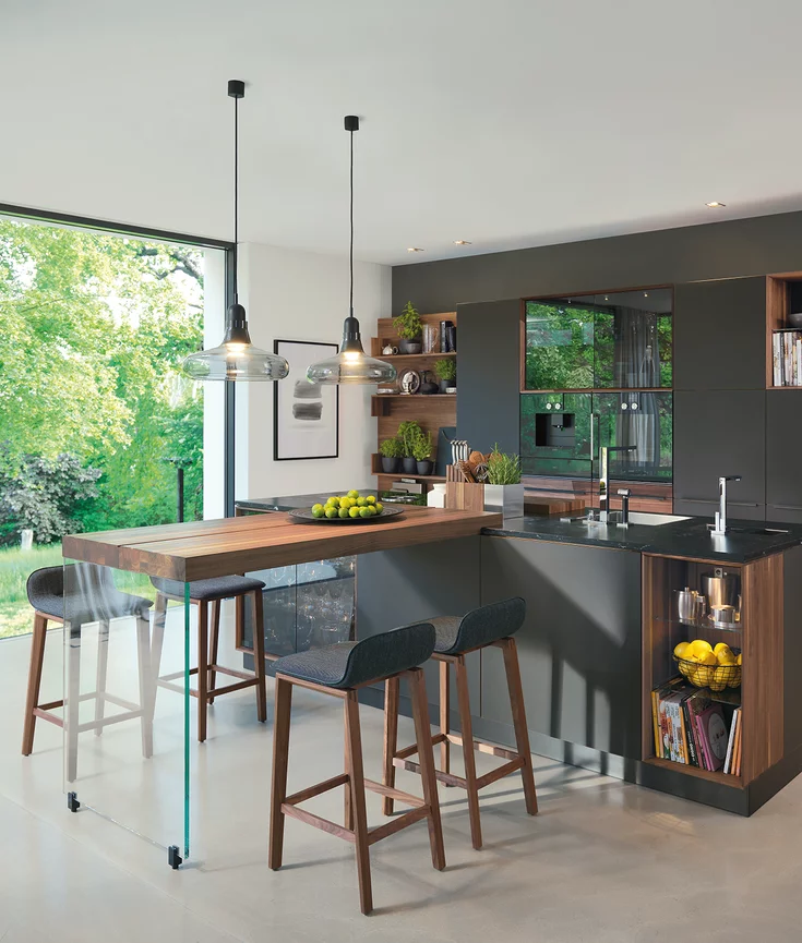 black line natural wood kitchen in walnut with coloured glass fronts, kitchen island with natural stone worktop and extension table with ark bar stools