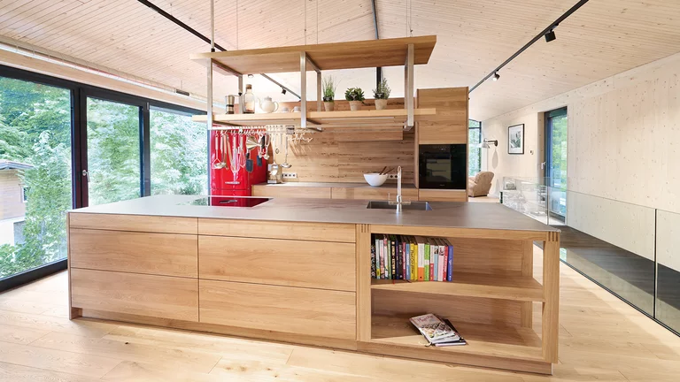 Customised freestanding kitchen in solid oak with accent back panel in venetian oak
