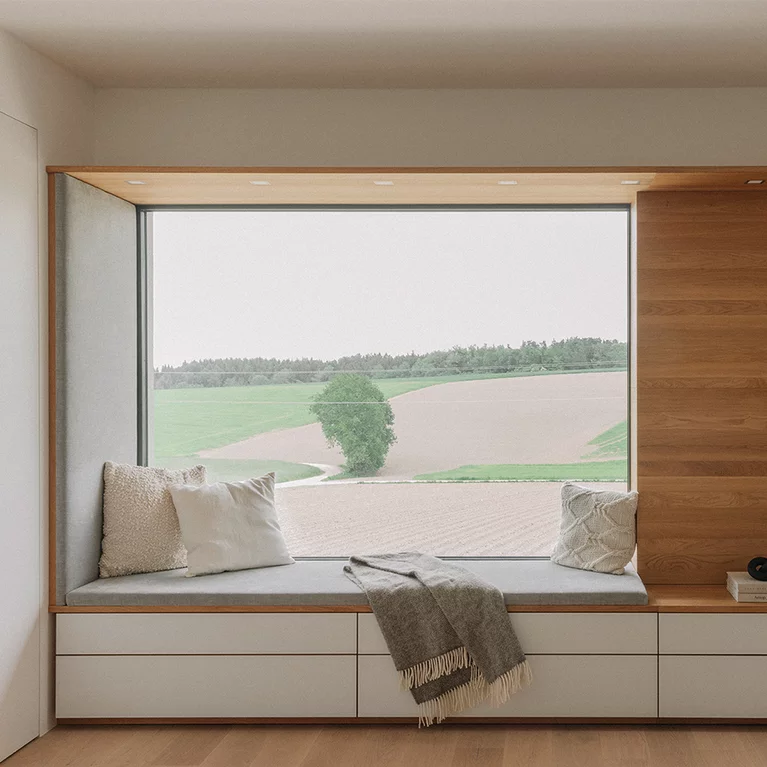 Large panoramic window with customised seating niche in natural oak oil