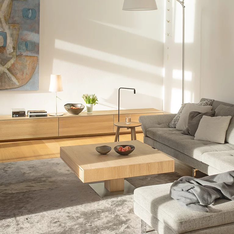 modern electric lift coffee table in oak white oil in the living room next to a filigno sideboard