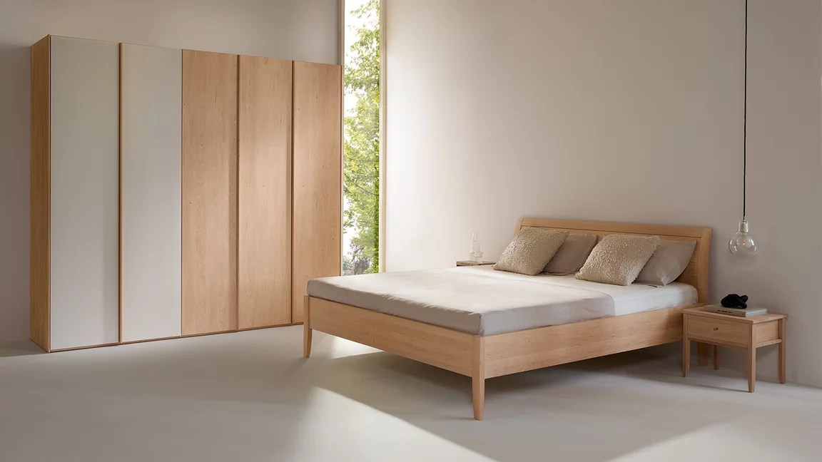 comfortable sesam bed in natural alder white oil with the sesam bedside cabinet and hinged door wardrobe