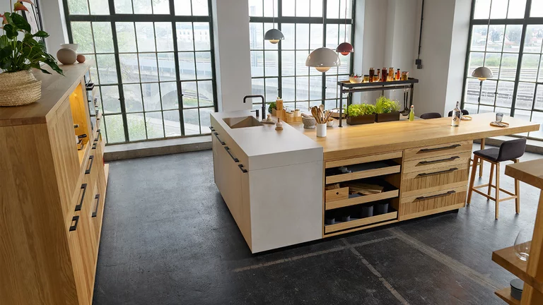 modern echt.zeit wooden kitchen in oak with kitchen block in ceramic phedra and integrated dining area with ark bar stools
