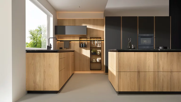 solid wood kitchen pur handleless in oak with coloured glass graphite grey matt and natural stone infinity brown with the elegant sign niche element illuminated