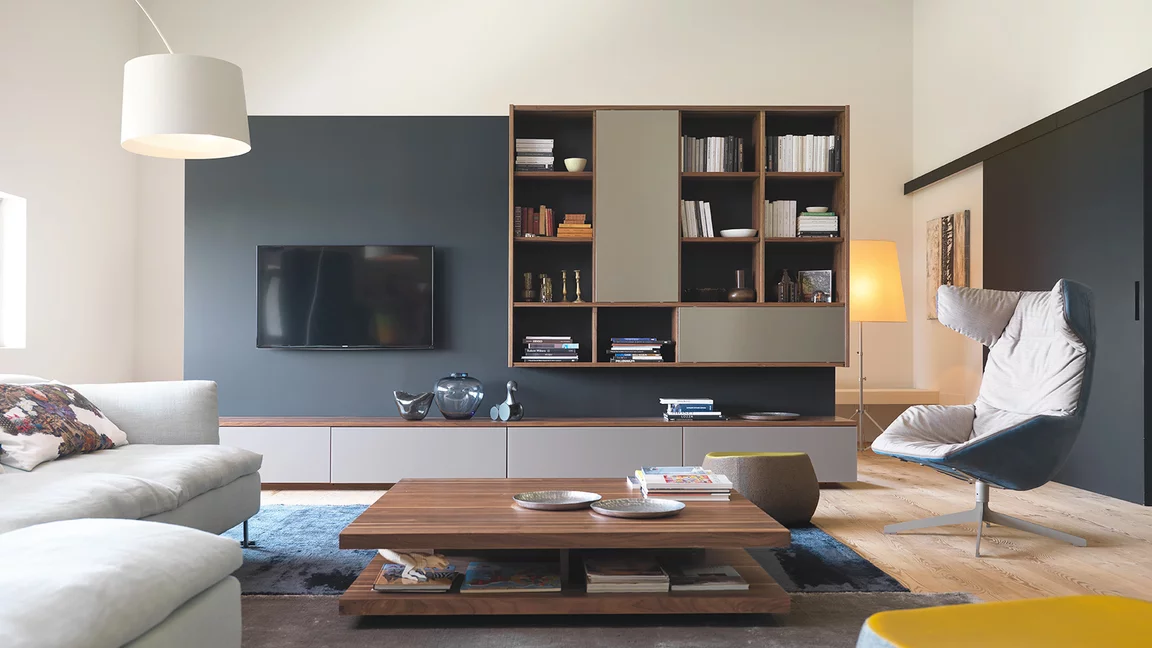 wooden cubus wall unit in walnut with c3 coffee table and graphic bookcase cubus wall unit, graphic design element and c3 coffee table in solid walnut and coloured glass