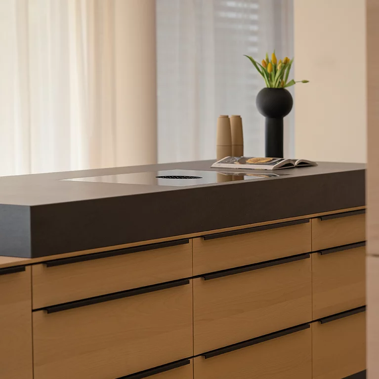 Solid wood cooking island in white beech oil with attached natural stone block