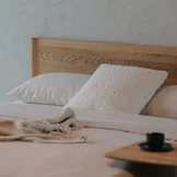 detailed view of the design of the solid wood headboard of the times bed in solid wild oak