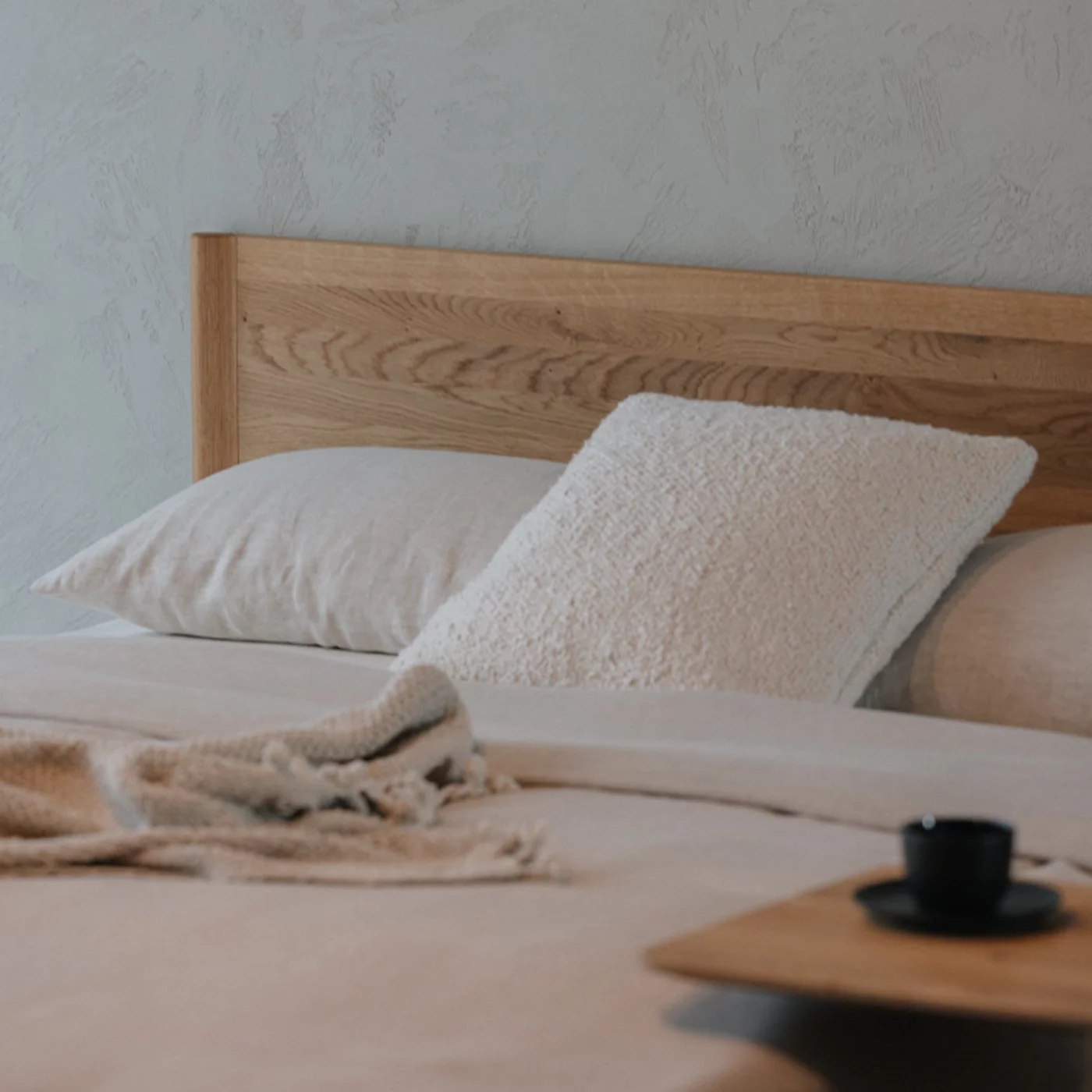 detailed view of the design of the solid wood headboard of the times bed in solid wild oak