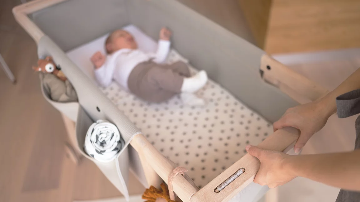 mobile baby cot made of wood with washable knitted fabric mobile cot in alder white oil with knitted fabric and washable fabric bags