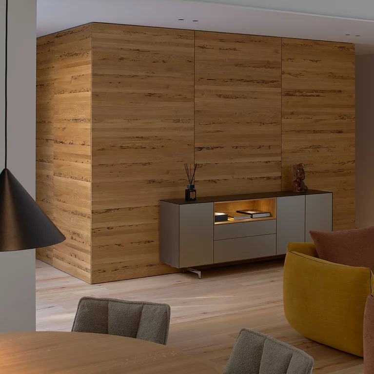 cubus pure sideboard with coloured glass casing on metal runners and illuminated oak niche in front of customised cabinet in venetian oak