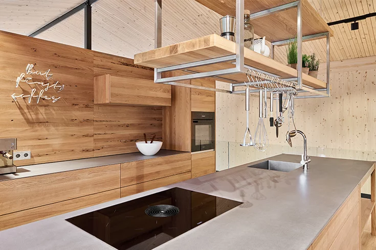 Customisable ceiling pendant with LED lighting in solid oak above kitchen island