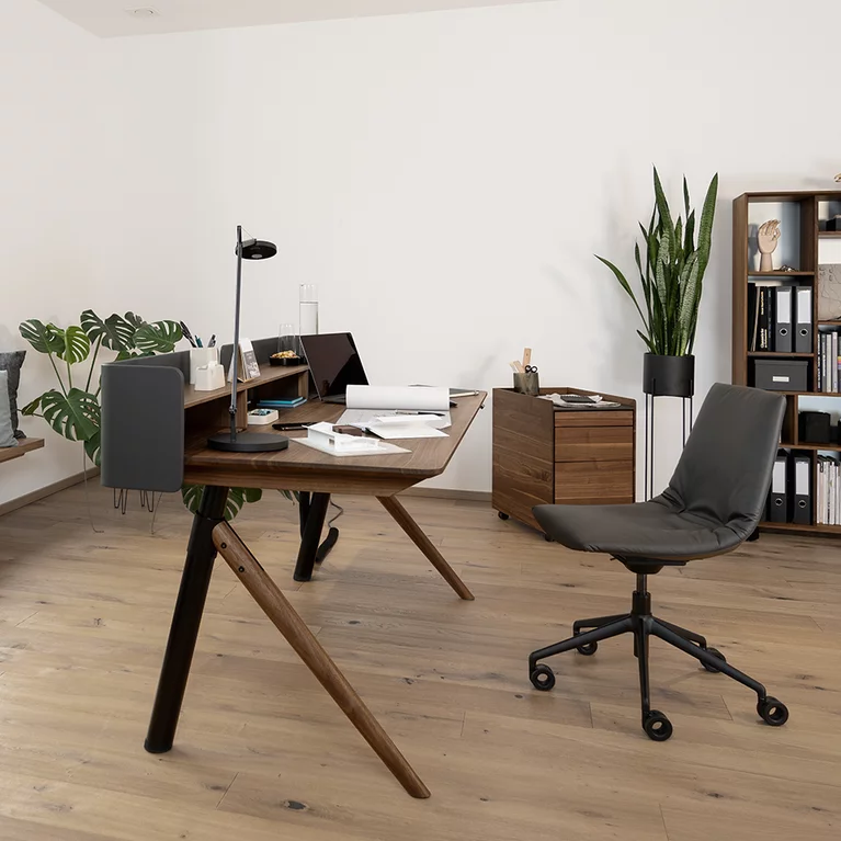 desk pedestal and desk in solid wood and leather with office swivel chair pisa desk pedestal with drawers and leather top in solid walnut behind pisa desk and lui office swivel chair in front of graphic office shelf