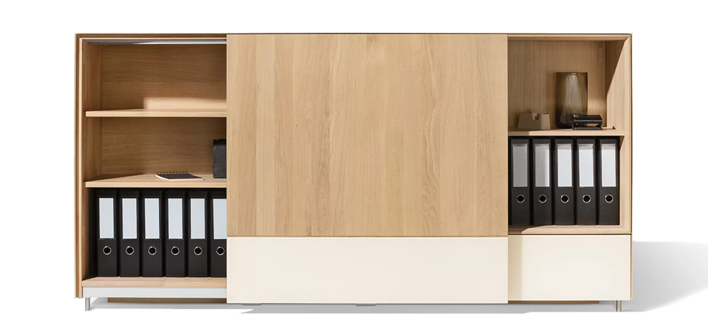 Sideboard with sliding door function in white oak oil and natural white coloured glass Sliding door sideboard in white oak oil with natural white coloured glass