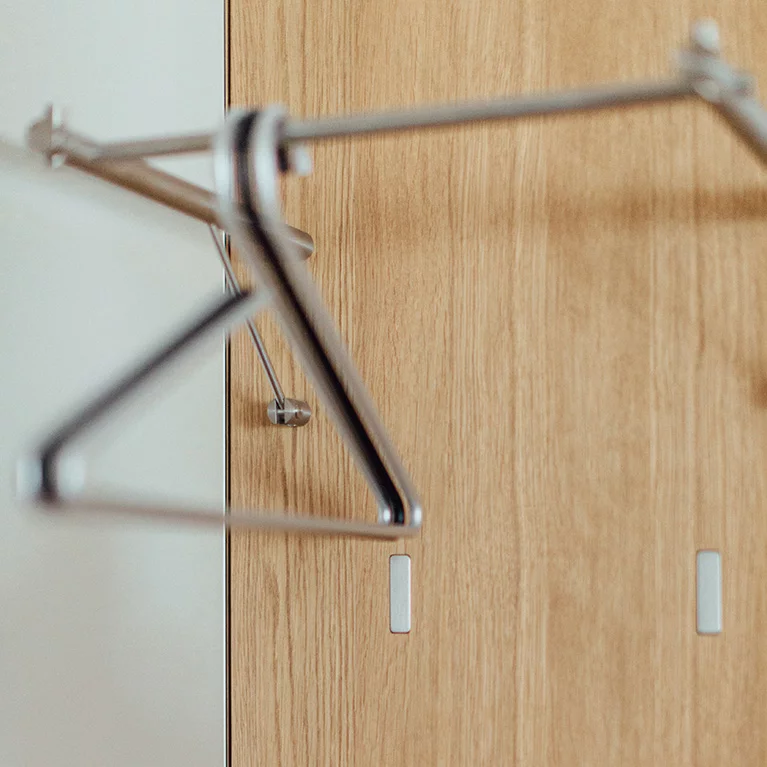 detailed view of a cubus wardrobe panel with metal folding hooks in oak white oil