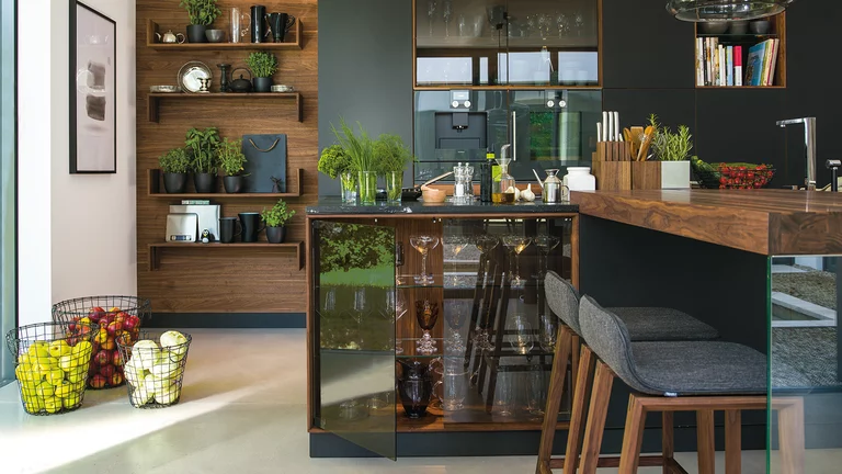 black line wooden kitchen with display cabinet, extension table and ark bar stools black line kitchen in solid walnut with transparent display cabinet and add-on table with ark bar stools