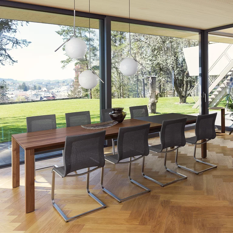 magnum extendable table in walnut with comfortable magnum cantilever chairs
