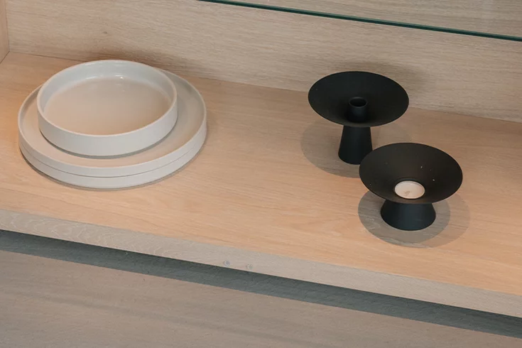 floor of a nox display cabinet in oak white oil, decorated with crockery and candlesticks
