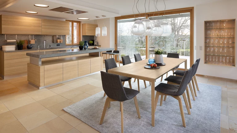 elegant k7 cooking island with height-adjustable worktop, linee wall unit and ark bar stools matching the tak table and lui chairs