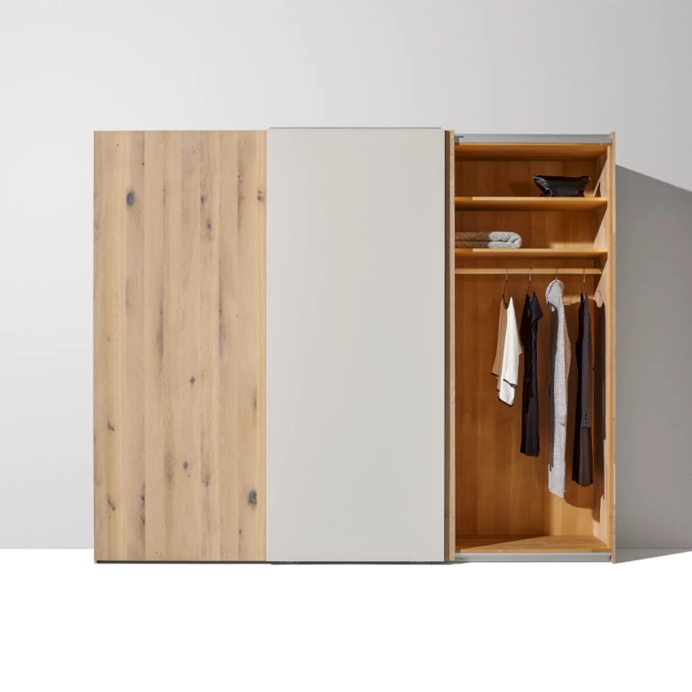 soft sliding door wardrobe in wild oak white oil with coloured glass front open