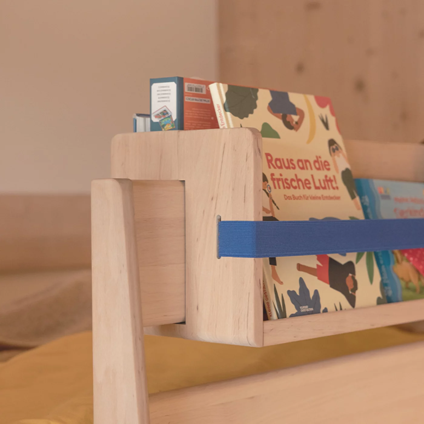 elegant decorative shelf made of solid wood with elastic bands, detailed view elegant decorative shelf in solid alder white oil with blue rubber bands, detailed view