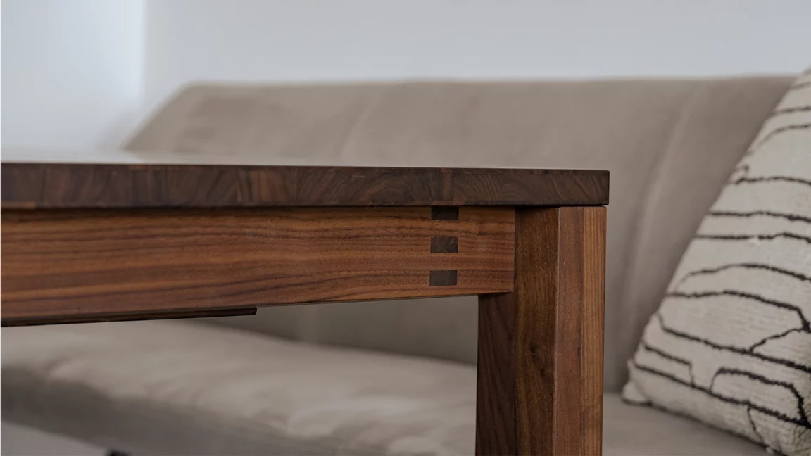 Detailed view of a wooden joint on the magnum dining table made with Austrian craftsmanship