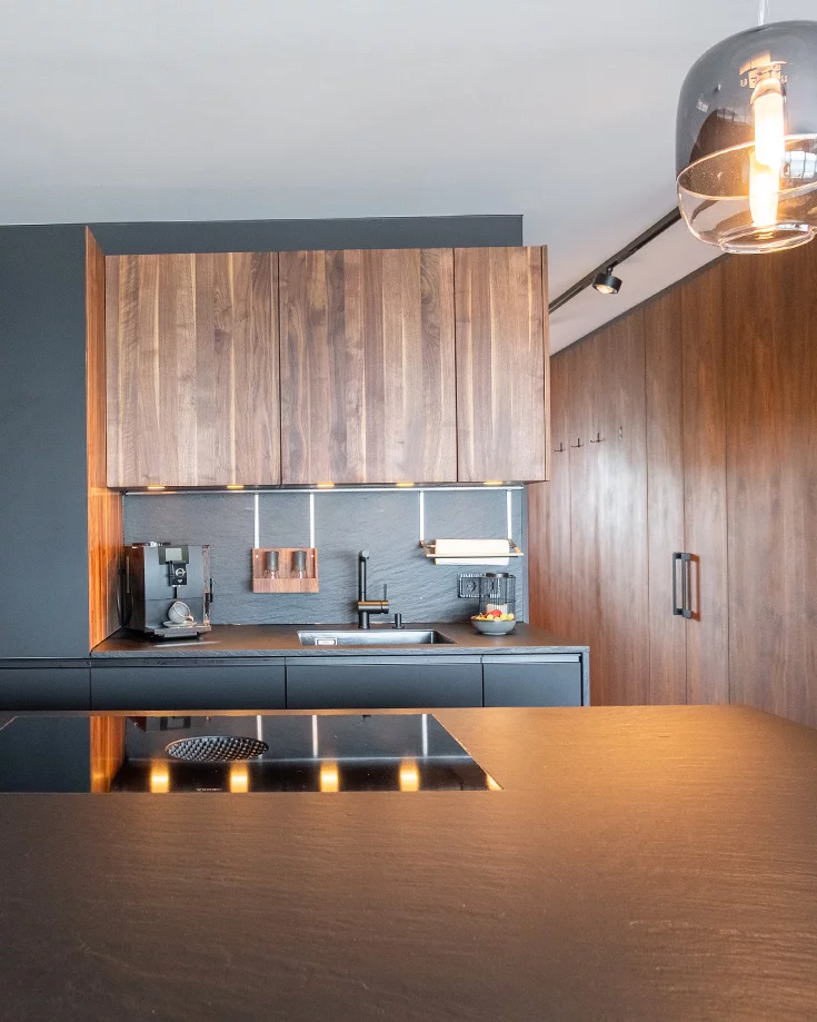 Modern solid walnut kitchen black line with black handle strip and ceramic elements in slate look