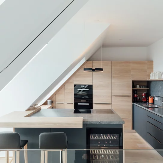 linee kitchen fitted into sloping roof with bar top, ceramic worktop and ark bar stools