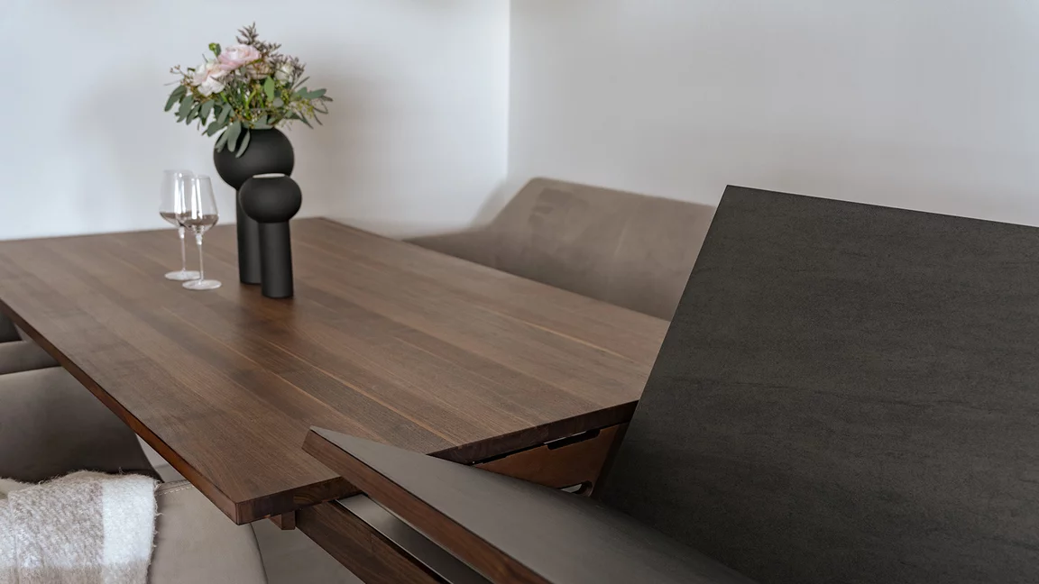 magnum extendable table made of solid walnut wood with insert tops that conveniently swivel out thanks to patented technology