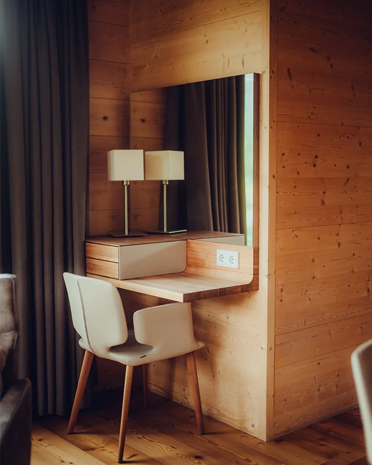 aye chair in front of solid wood riletto make-up console with leather cover