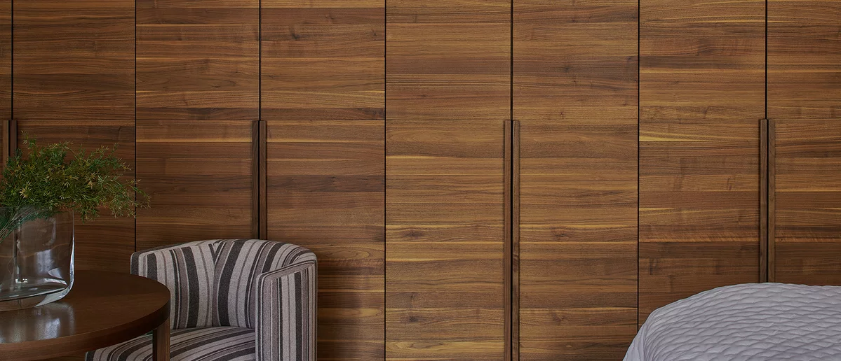 lunetto hinge-door wardrobe with handle strips in solid walnut