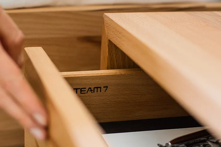 side furniture lunetto in beech, drawer with laser engraving TEAM 7, detailed view
