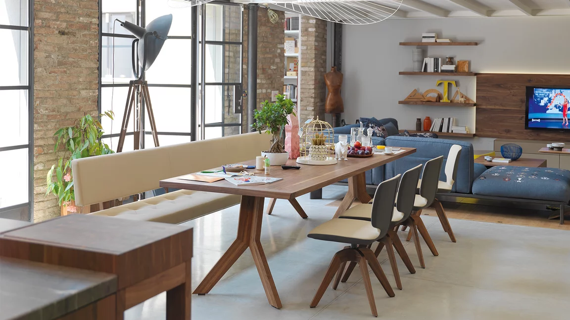 modern yps extendable dining table in solid walnut with the aye swivel base chair and the yps upholstered bench with backrest