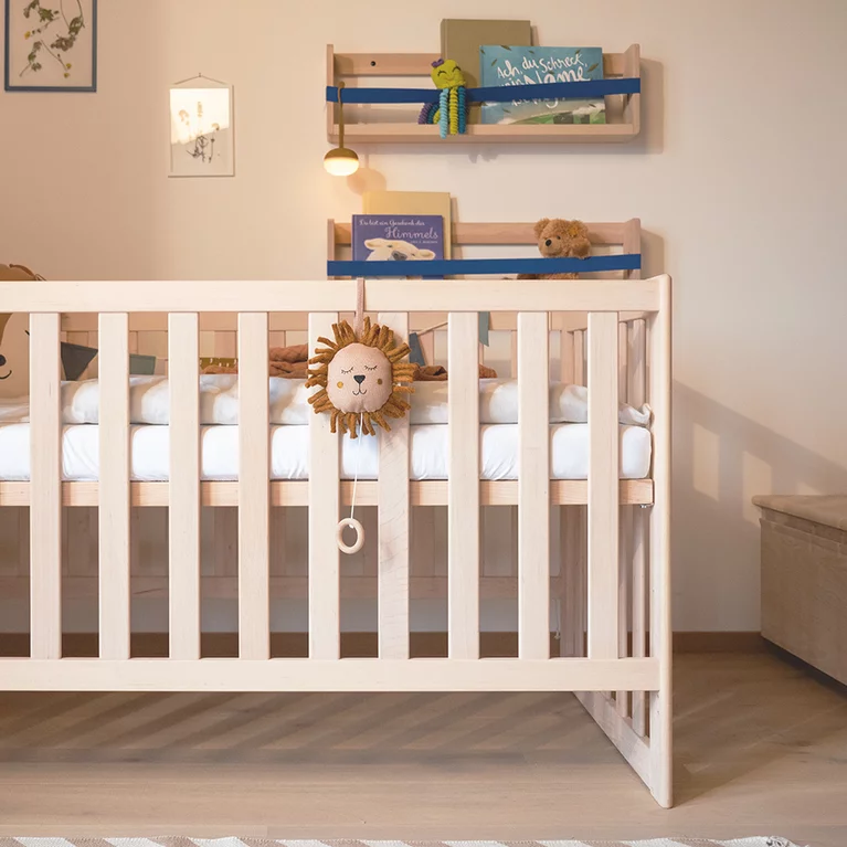wooden cot with height-adjustable slatted frame and decorative shelves kids cot in alder white oil with height-adjustable slatted frame and practical decorative shelves