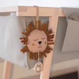 wooden baby cot with knitted and fabric bags, detailed view baby cot in alder white oil with special knitted fabric and fabric pockets, detailed view