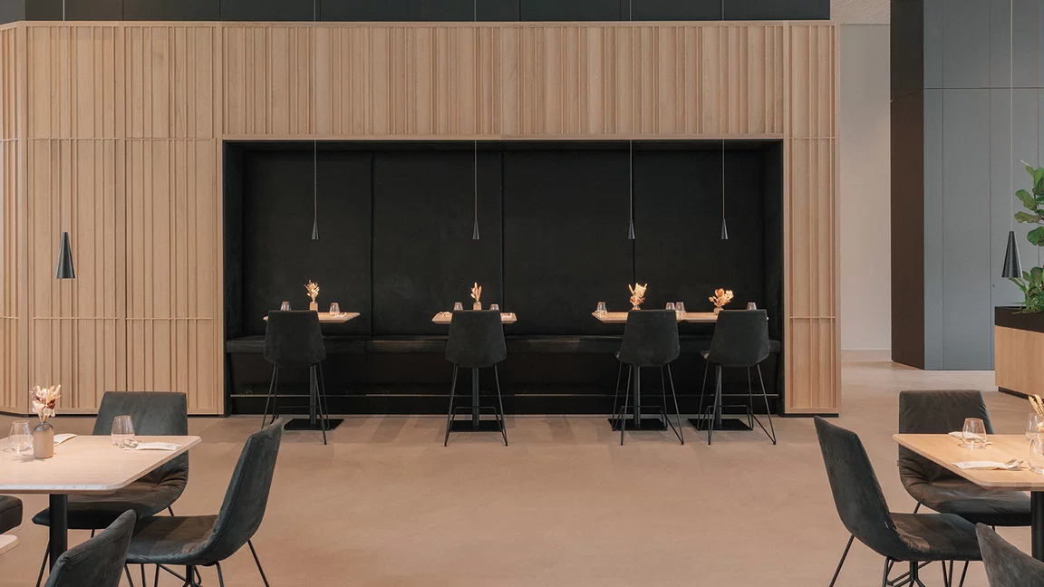 Elegant restaurant seating with lui bar stools and solid wood tables in natural oak oil