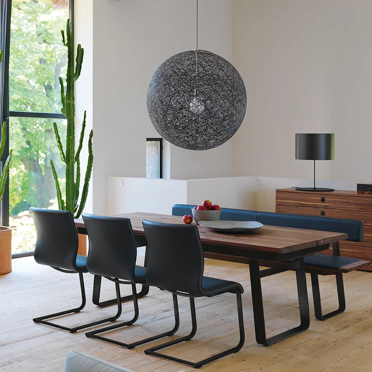 nox bench in walnut with leather backrest and metal sliders in matt black together with the nox table and magnum cantilever chairs