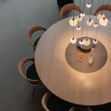 miró round dining table made of solid wood in oak white oil with integrated turntable and comfortable girado chairs
