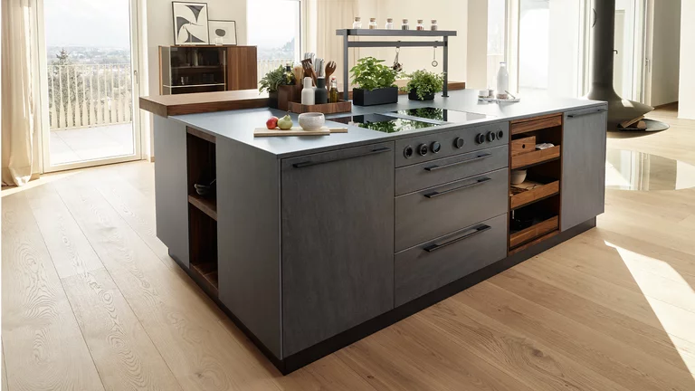 echt.zeit natural wood kitchen in walnut cooking island with ceramic fronts in basalt black
