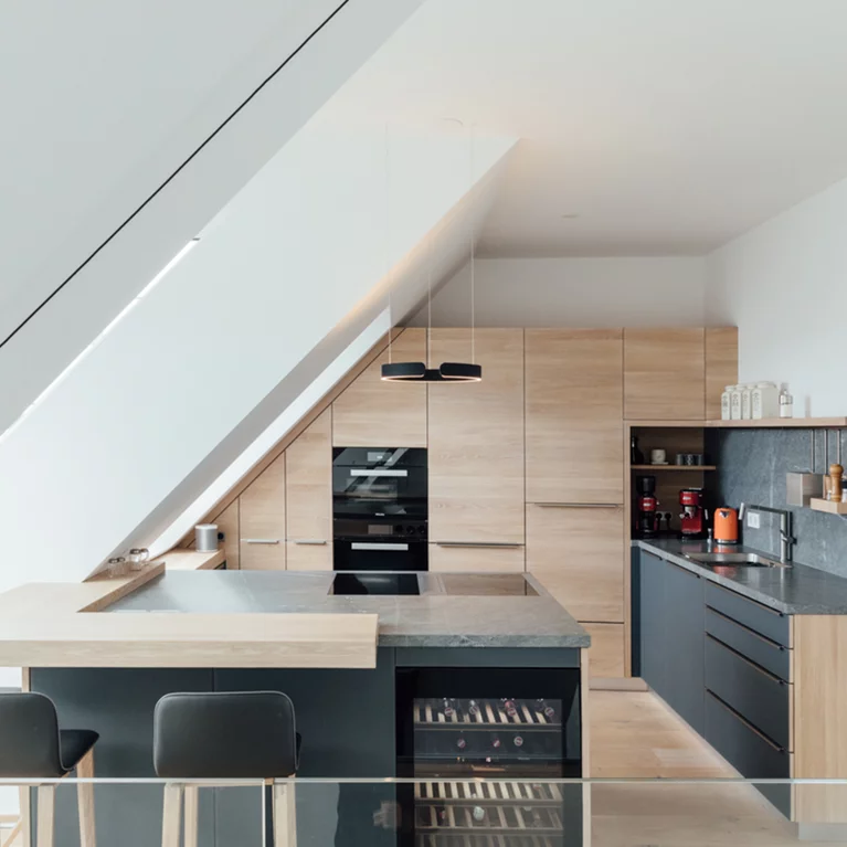 linee kitchen fitted into sloping roof with bar top, ceramic worktop and ark bar stools