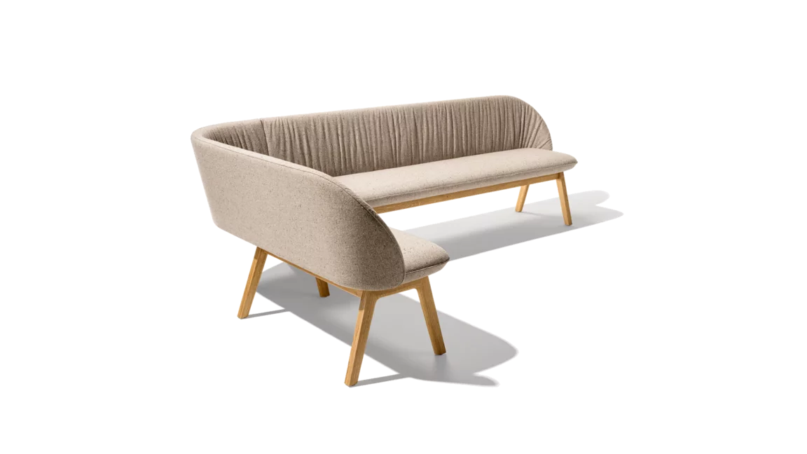 flor upholstered chairs in fabric with wooden frame in white alder, taso table and the flor bench, cubus pure sideboard behind it