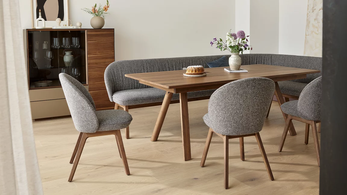 flor dining chairs in fabric seat shell and fabric backrest with wooden frame in walnut and taso solid dining table