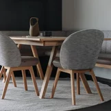 flor upholstered chairs with fabric and wooden frame in walnut, taso table and flor bench