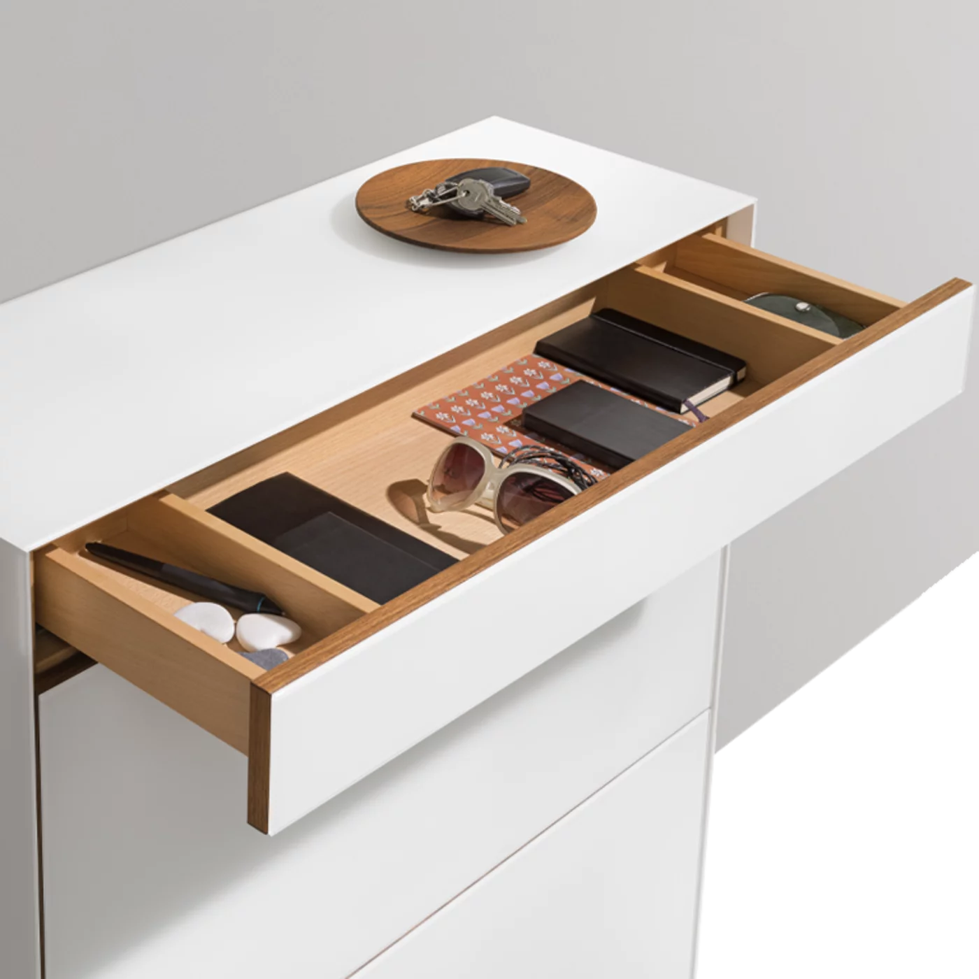 cubus shoe flap chest of drawers in solid walnut with coloured glass surround
