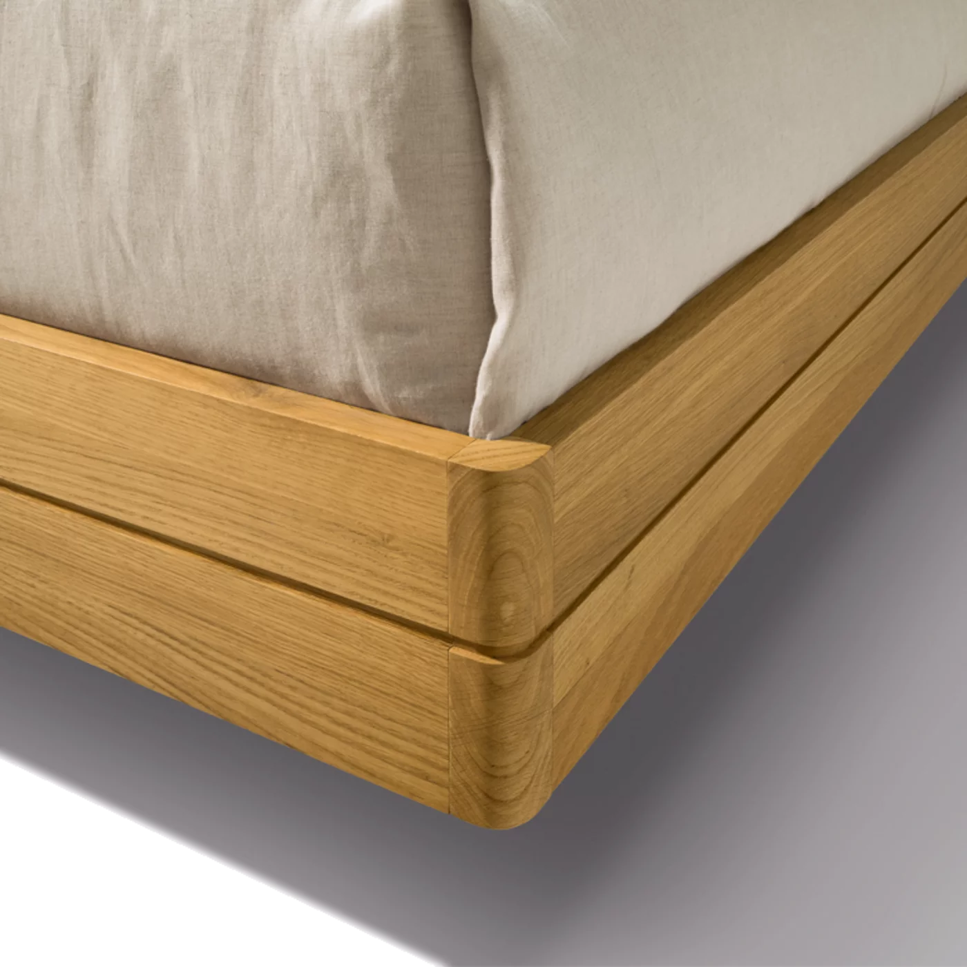 float bedside cabinet in oak with rounded corners