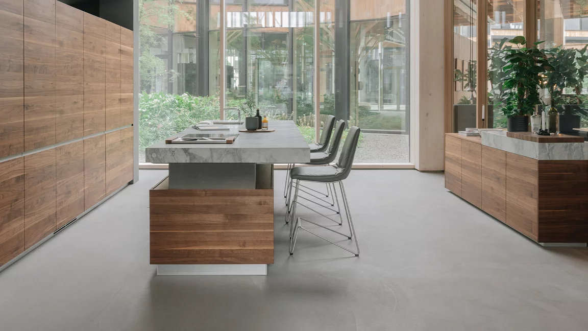 lui bar stool in leather with complementary frame and k7 kitchen in walnut wood