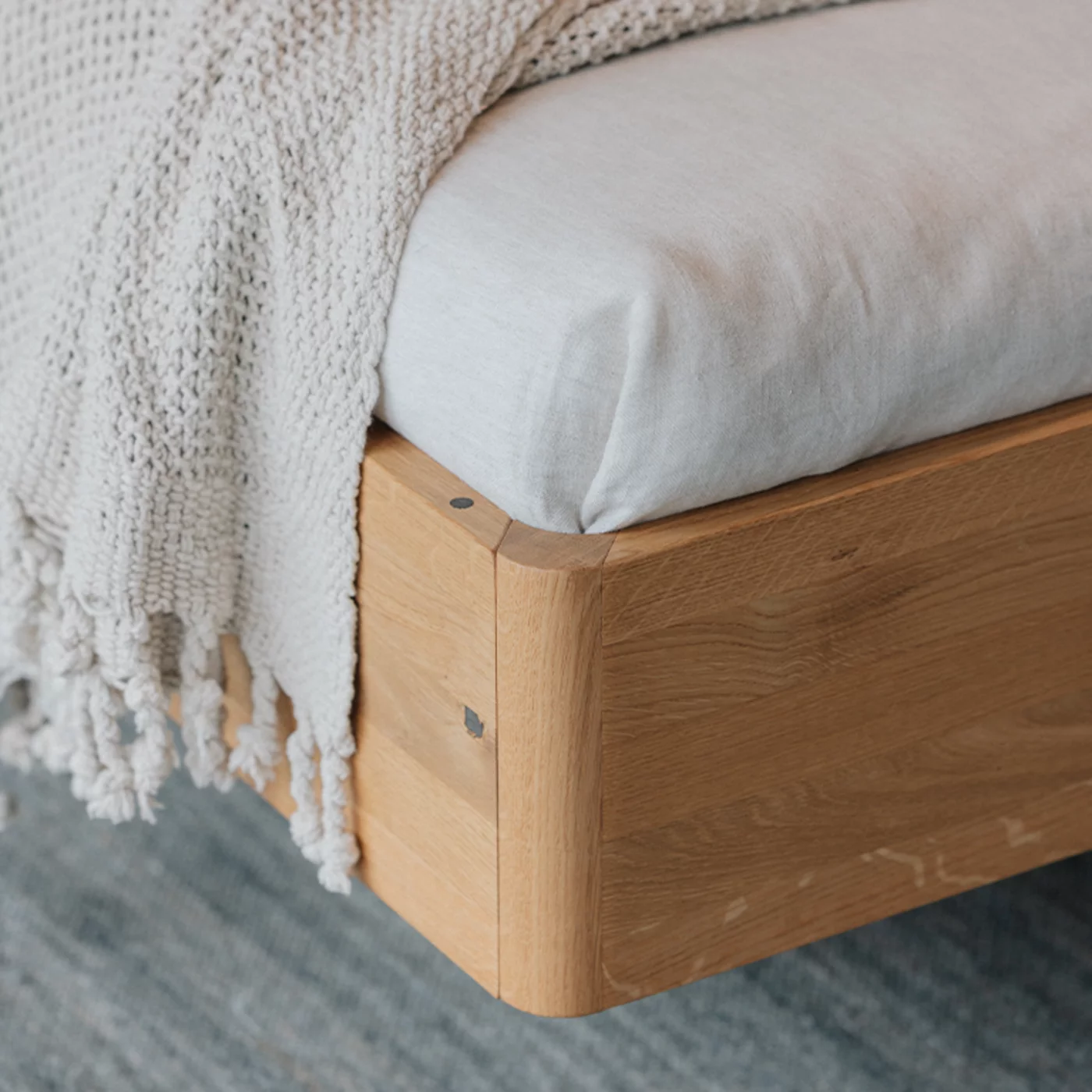 detailed view of the solid wood connection of the footboard of the times bed in wild oak