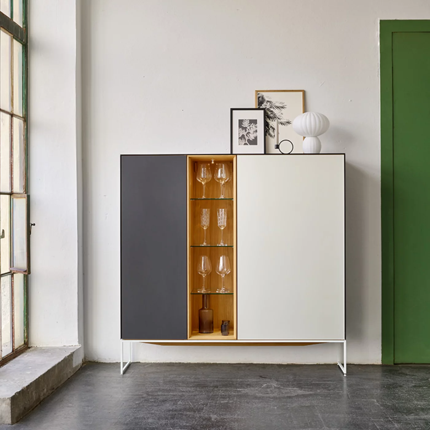 modern cubus pure wooden highboard made of solid oak with side panels, doors and top panel in coloured glass on a matt snow white metal frame